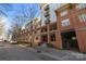 An eye-level exterior shot of a beautiful brick condo with balconies in a serene, quiet neighborhood at 1101 W 1St St # 124, Charlotte, NC 28202