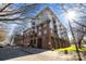 Beautiful low-angle shot of a brick condo building with balconies and a lush lawn on a sunny day at 1101 W 1St St # 124, Charlotte, NC 28202