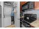 Convenient laundry area with a stackable washer and dryer combo, shelves, and storage space at 1101 W 1St St # 124, Charlotte, NC 28202
