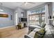 Comfortable living room with large windows, gray sectional sofa, wood floors, and television at 1101 W 1St St # 124, Charlotte, NC 28202