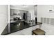 Modern kitchen with gray cabinetry, stainless steel appliances, and dark countertops with bar seating at 11036 Harrowfield Rd, Charlotte, NC 28226