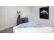 A modern bedroom with neutral tones features contemporary decor, including a striking piece of art at 11205 Cardinal Creek Ave, Charlotte, NC 28215