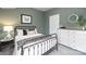 Cozy bedroom with a metal frame bed, patterned bedding, and a white dresser, ideal for a restful retreat at 11205 Cardinal Creek Ave, Charlotte, NC 28215
