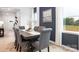 Elegant dining room featuring a stylish table with seating for six, complemented by a view of the outdoors at 11205 Cardinal Creek Ave, Charlotte, NC 28215