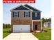 Charming two-story home featuring a brick facade and a two-car garage at 11205 Cardinal Creek Ave, Charlotte, NC 28215