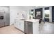 Modern kitchen features white cabinetry, stainless steel appliances, and an island with a sink and dishwasher at 11205 Cardinal Creek Ave, Charlotte, NC 28215