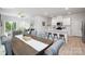 Open-concept living space combines dining, kitchen, and living areas for seamless entertaining and everyday living at 11205 Cardinal Creek Ave, Charlotte, NC 28215