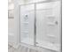 A modern shower unit showcases a clean design with built-in shelving and sleek glass doors at 11205 Cardinal Creek Ave, Charlotte, NC 28215