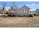 Side view of the home, with steps leading to the backyard, and a grass lawn at 114 Glen Rae Sw St, Concord, NC 28025