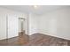 Bedroom with wood-look flooring, neutral paint and an interior entrance at 114 Glen Rae Sw St, Concord, NC 28025