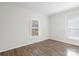 Bright bedroom with wood-look floors and two windows at 114 Glen Rae Sw St, Concord, NC 28025