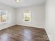 Bedroom with wood-look floors and two windows at 114 Glen Rae Sw St, Concord, NC 28025