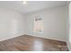 Cozy bedroom with wood-look flooring, natural light and neutral paint at 114 Glen Rae Sw St, Concord, NC 28025
