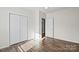 Bedroom with wood-look flooring and large closet at 114 Glen Rae Sw St, Concord, NC 28025