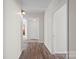 Hallway featuring wood flooring and neutral paint, leading to other rooms in the house at 114 Glen Rae Sw St, Concord, NC 28025