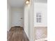 Hallway with wood floors and white walls leading to a light-filled room with a window at 114 Glen Rae Sw St, Concord, NC 28025