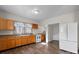 Bright and functional kitchen with wood cabinets and modern white refrigerator and oven at 114 Glen Rae Sw St, Concord, NC 28025