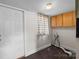 Laundry area with a side entrance, overhead cabinets, and durable flooring at 114 Glen Rae Sw St, Concord, NC 28025