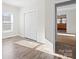 Sunlit room featuring wood floors, a closet, and an entrance to an adjacent room at 114 Glen Rae Sw St, Concord, NC 28025
