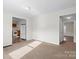 Open-concept living space with carpet and a clear view into the kitchen with white appliances at 114 Glen Rae Sw St, Concord, NC 28025