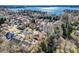 Aerial view of a residential neighborhood with mature trees and lake views at 127 Lakewood Circle Dr, Mooresville, NC 28117