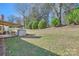 Expansive backyard featuring a covered patio, lush greenery, and mature trees for shade and privacy at 127 Lakewood Circle Dr, Mooresville, NC 28117