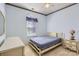 Bedroom with light blue walls, a ceiling fan, neutral carpet, and a matching bed and dresser set at 127 Lakewood Circle Dr, Mooresville, NC 28117