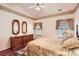Bedroom with a ceiling fan, floral wallpaper, a dresser, two lamps, and hardwood floors at 127 Lakewood Circle Dr, Mooresville, NC 28117