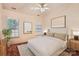 Staged bedroom with a ceiling fan, two windows, modern lamps, and hardwood floors at 127 Lakewood Circle Dr, Mooresville, NC 28117
