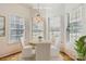 Bright breakfast nook area featuring three windows and modern chandelier at 127 Lakewood Circle Dr, Mooresville, NC 28117