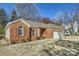 Charming brick home with a manicured lawn and attached two-car garage at 127 Lakewood Circle Dr, Mooresville, NC 28117