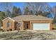 Charming brick home with a well-manicured lawn and attached two-car garage at 127 Lakewood Circle Dr, Mooresville, NC 28117