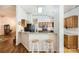 Eat-in kitchen featuring granite countertops, wood cabinets, breakfast bar with seating, and hardwood floors at 127 Lakewood Circle Dr, Mooresville, NC 28117