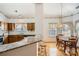 Kitchen and breakfast nook with granite counters, wood cabinets, pendant lighting, and hardwood floors at 127 Lakewood Circle Dr, Mooresville, NC 28117