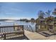 Scenic lake view featuring a wooden dock, waterfront gazebo, and sparkling water at 127 Lakewood Circle Dr, Mooresville, NC 28117
