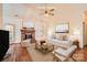 Virtually staged living room featuring a brick fireplace and neutral furniture at 127 Lakewood Circle Dr, Mooresville, NC 28117