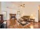 Cozy living room with a brick fireplace and wood floors at 127 Lakewood Circle Dr, Mooresville, NC 28117