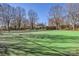 Well-maintained tennis court surrounded by mature trees and greenery at 127 Lakewood Circle Dr, Mooresville, NC 28117