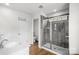 Modern bathroom with glass-enclosed shower, white vanity, and wood-look tile flooring at 13044 Cottage Crest Ln, Charlotte, NC 28273