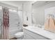 Well-lit bathroom features shower with curtain, modern sink, and neutral walls at 13044 Cottage Crest Ln, Charlotte, NC 28273