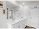 Bright bathroom with double sinks, white cabinets, and large mirror at 13044 Cottage Crest Ln, Charlotte, NC 28273