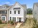 Charming two-story townhome with a brick-accented front and a decorative wreath on the front door at 13044 Cottage Crest Ln, Charlotte, NC 28273