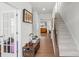 Hallway view with stairs, wood floors, and a view to the living room at 13044 Cottage Crest Ln, Charlotte, NC 28273