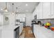 Bright kitchen boasts white cabinets, stainless steel appliances, and a large island with pendant lighting at 13044 Cottage Crest Ln, Charlotte, NC 28273