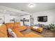 Spacious living room featuring modern decor, wood floors, and an open layout at 13044 Cottage Crest Ln, Charlotte, NC 28273
