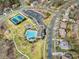 Scenic aerial shot showcasing community amenities including a pool, tennis courts, playground, and ample parking at 13114 Long Common Pkwy, Huntersville, NC 28078