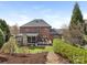 Spacious backyard with a screened porch, deck, and manicured landscaping, perfect for outdoor enjoyment at 13114 Long Common Pkwy, Huntersville, NC 28078