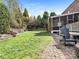 Expansive backyard with stone patio, screened porch, and beautifully landscaped garden at 13114 Long Common Pkwy, Huntersville, NC 28078