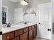 Bathroom with a double vanity featuring wood cabinets and dolphin-themed décor at 13114 Long Common Pkwy, Huntersville, NC 28078
