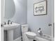Bathroom with pedestal sink, toilet, and decorative wall art at 13114 Long Common Pkwy, Huntersville, NC 28078